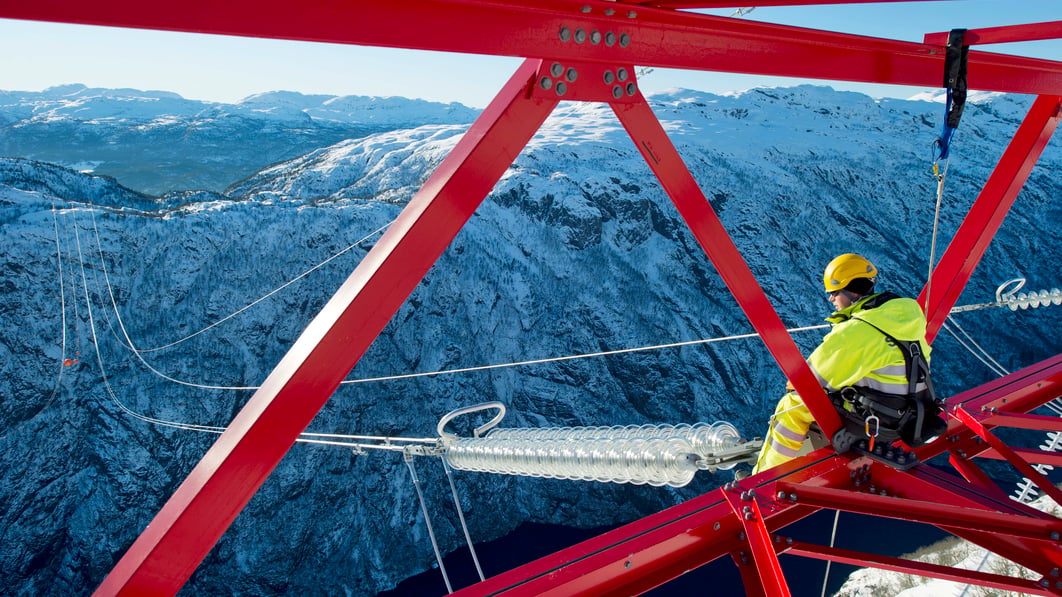 Person high up in a mast during the construction of Ofoten-Balsfjord