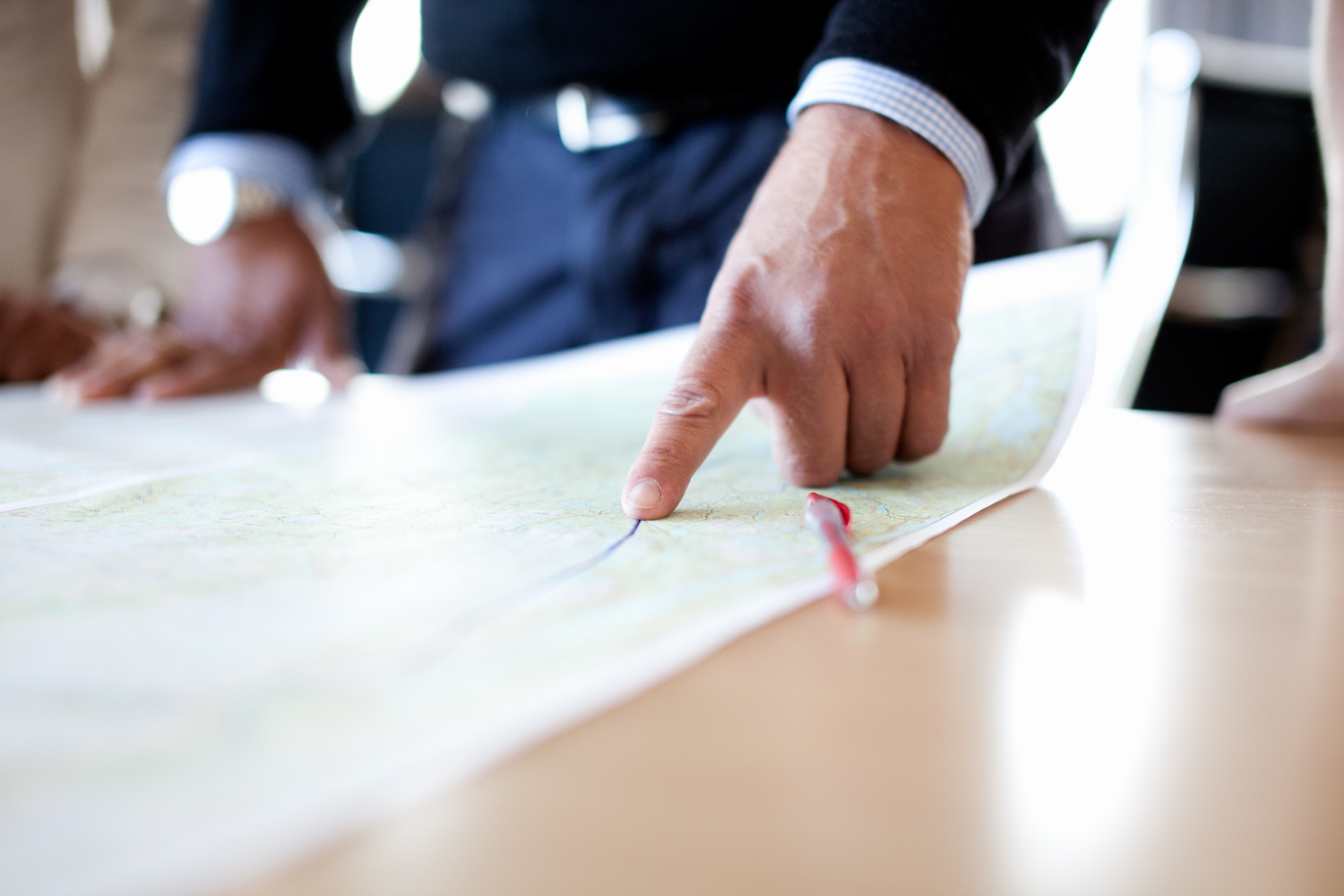 Finger pointing at a map