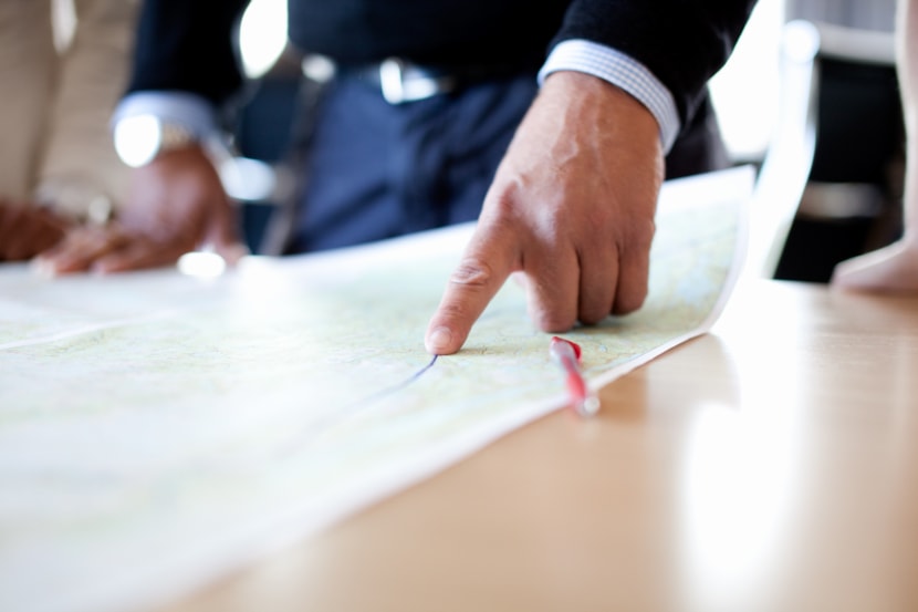 Finger pointing at a map