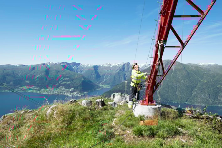 mann ved fot av strømmast