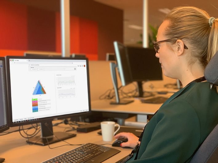A picture of a person in front of a computer screen